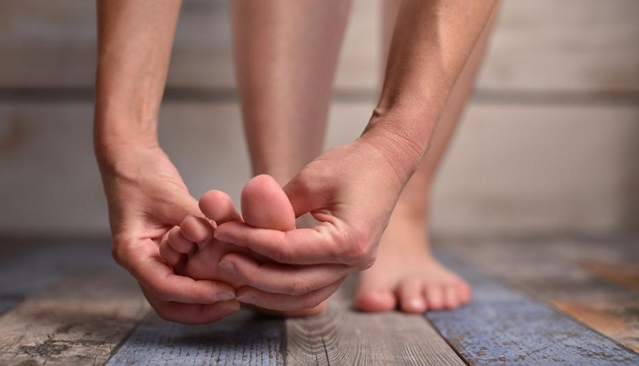 photo from the AARP of hands holding a painful foot