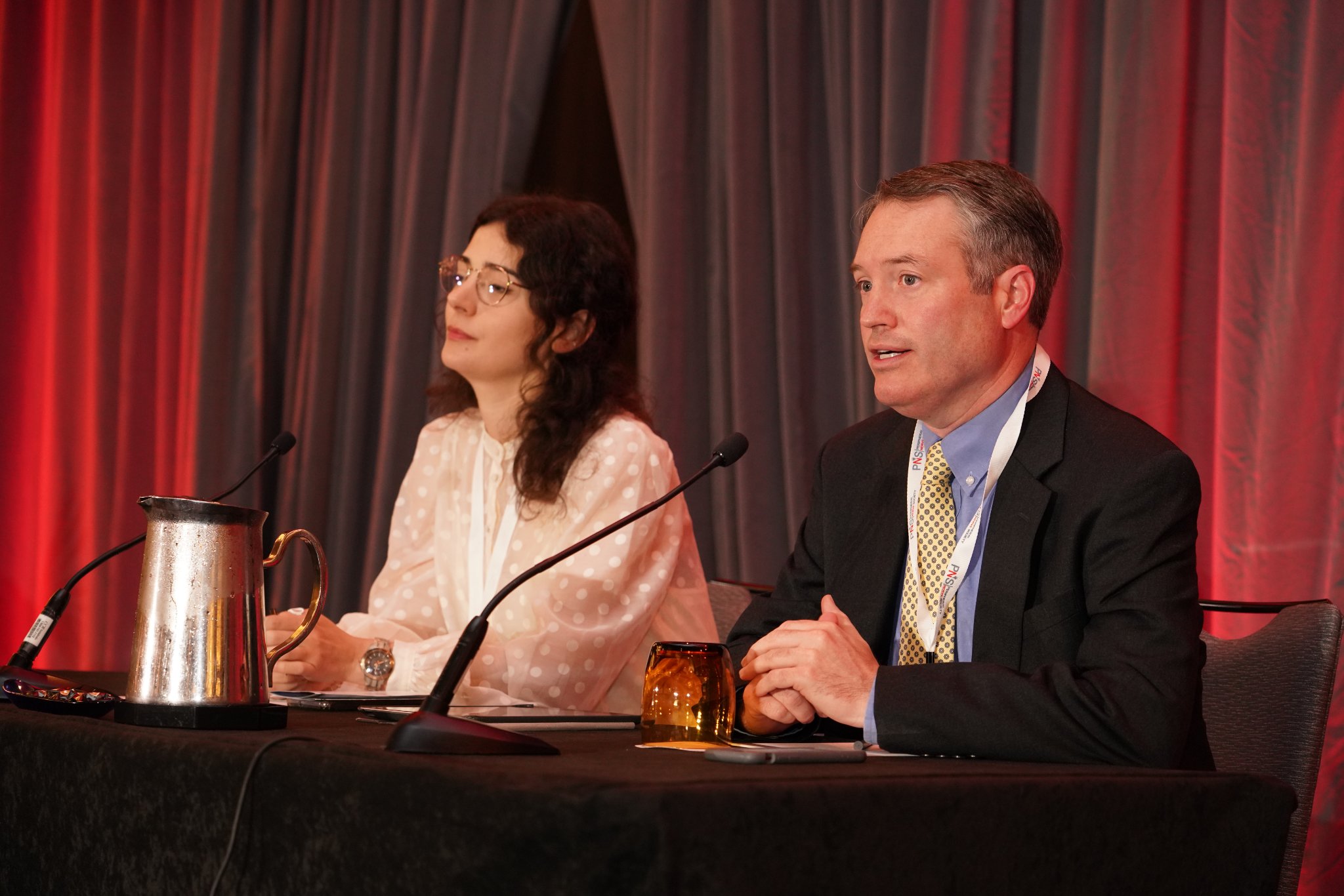 Photo of Drs. Brian Callaghan and Mirlinda Ademi chairing their section of the Peripheral Nerve Society Annual Meeting