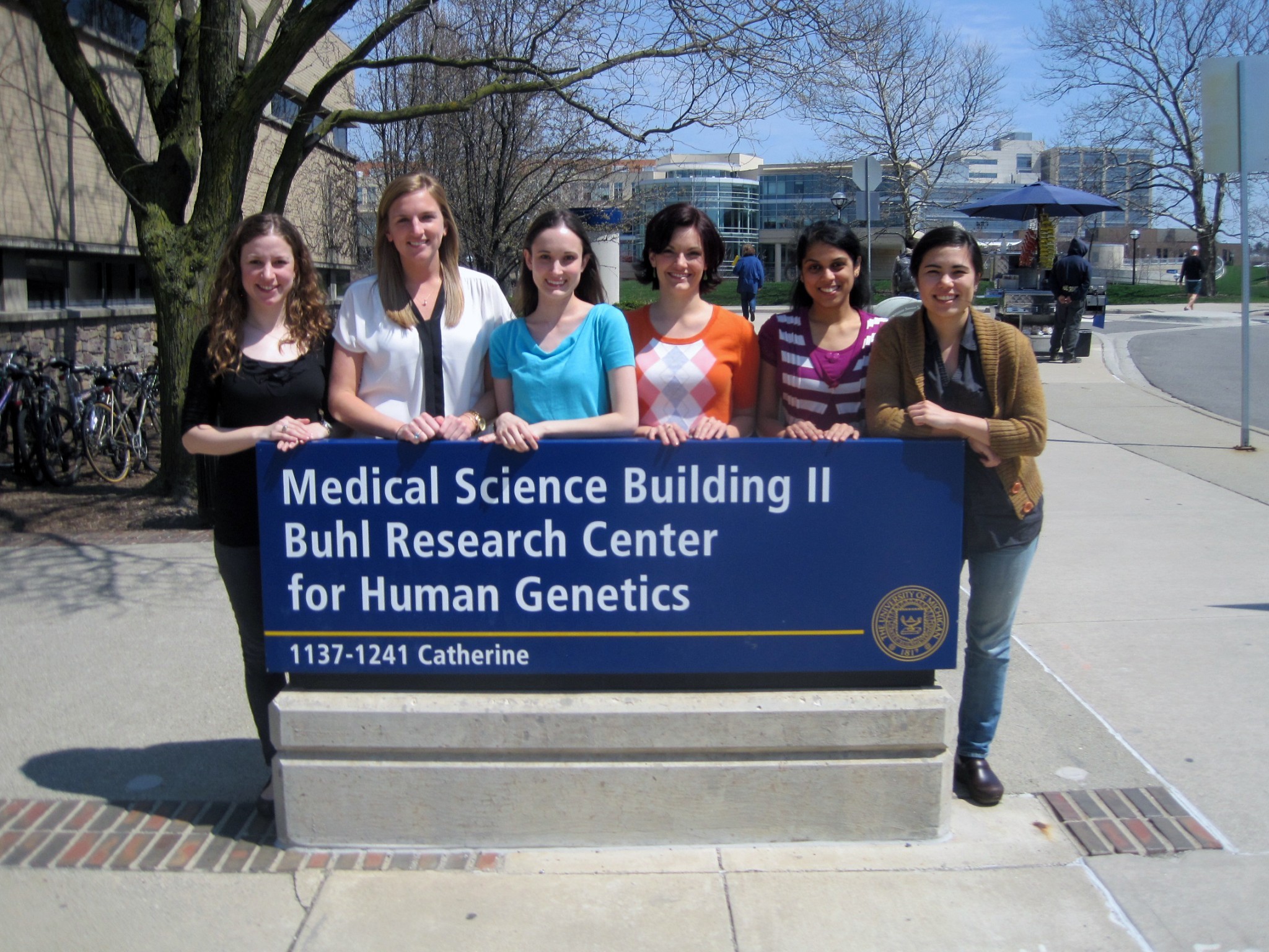 Genetics Counseling Students in front of department sign. 