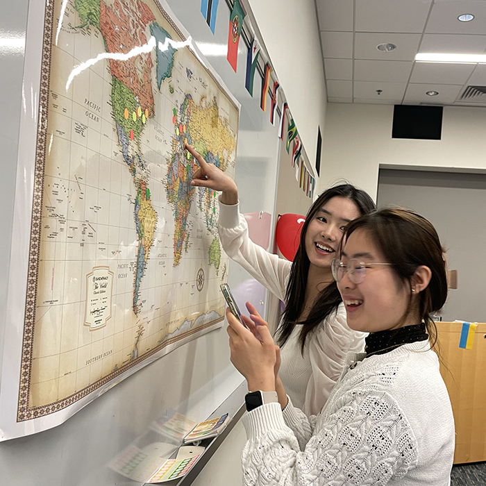 Asian looking at world map