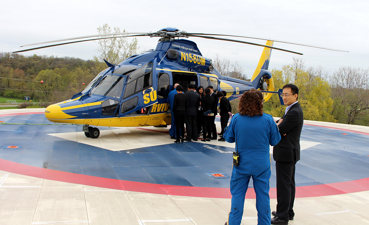 Yuping Yang tours Survival Flight operations during a visit to Ann Arbor in 2019. 