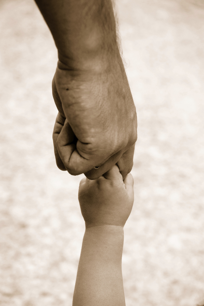 Adult holding a child's hand