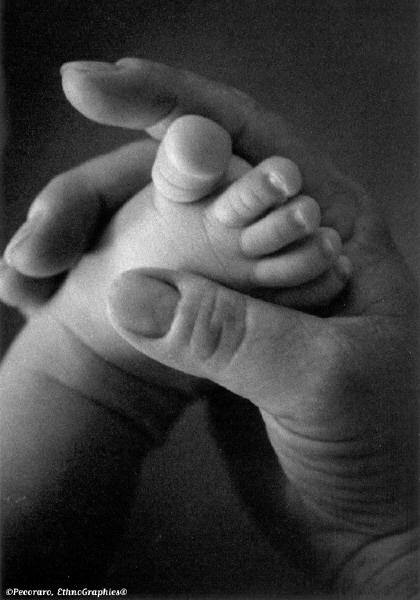 Adult holding a child's foot