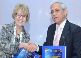 Mary Sue Coleman shaking hands with a representative from AIIMS