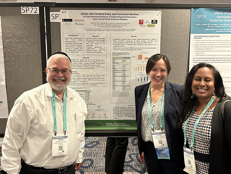 Dr. Ed Hurvitz stands with two of his co-investigators in front of their research poster titled "Adults with Cerebral Palsy and the Chronic Pain Experience"