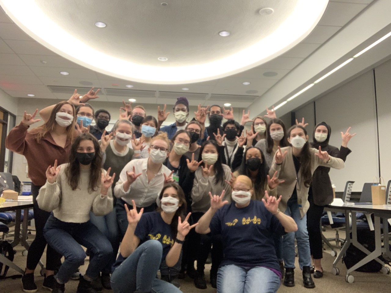 First-year medical students with the University of Michigan Medical School sign the message 'I Love You' in a classroom in the Taubman Health Sciences Library