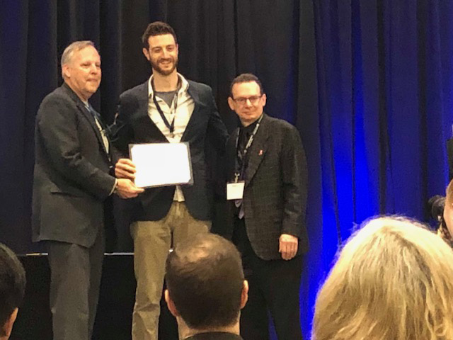 Dr. Sean Smith receiving his certificate for completing the Physiatric Academic Leadership Program at the Association of Academic Physiatrists meeting in Atlanta
