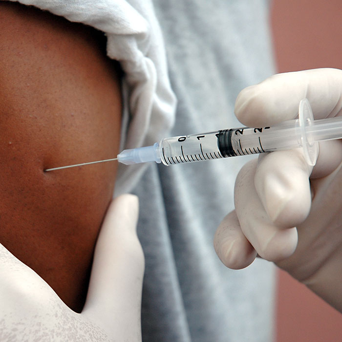 A doctor administers a vaccination to a patient's arm