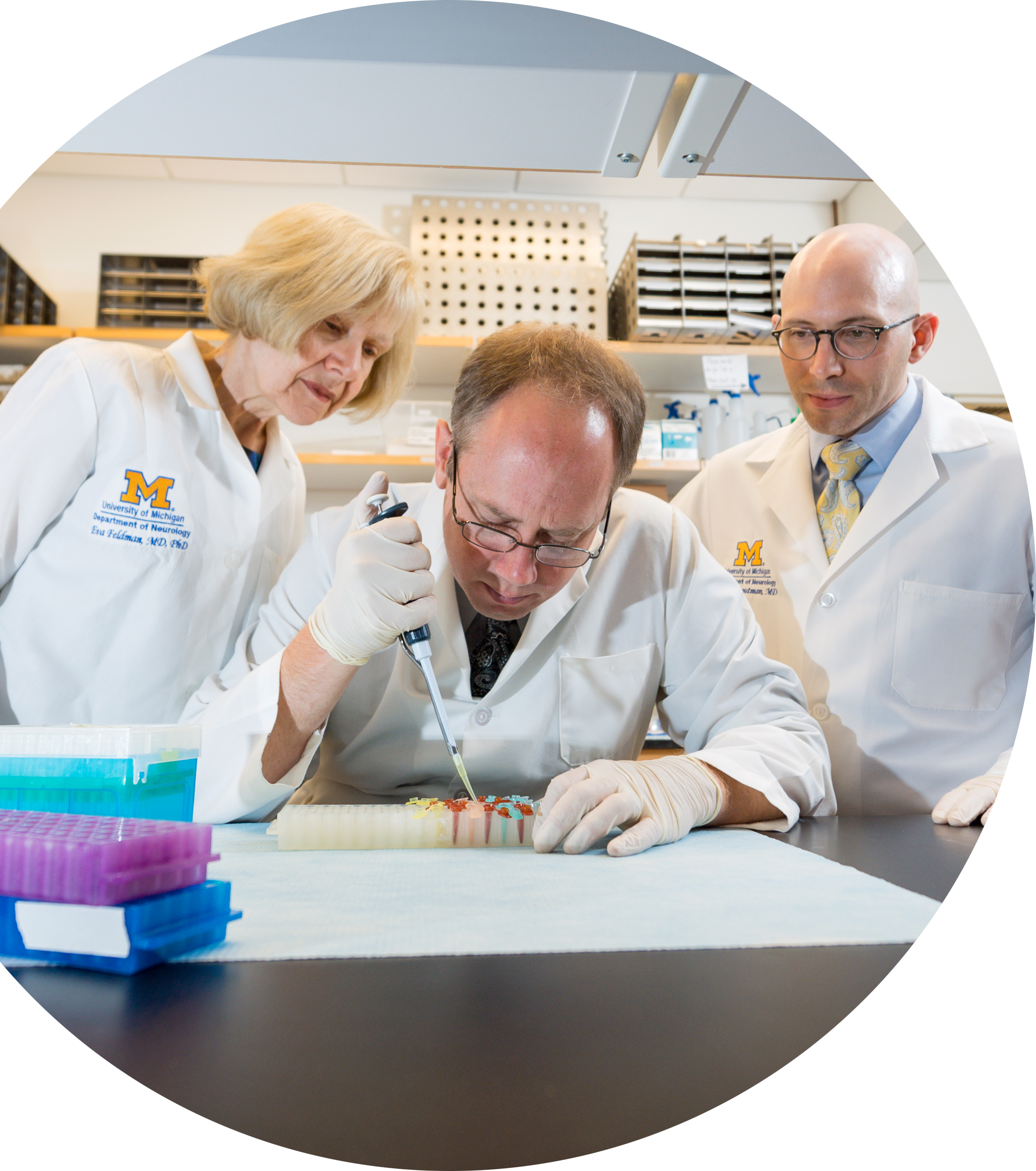 photo of Dr. Eva Feldman, Dr. Benjamin Murdock and Dr. Stephen Goutman working in the lab