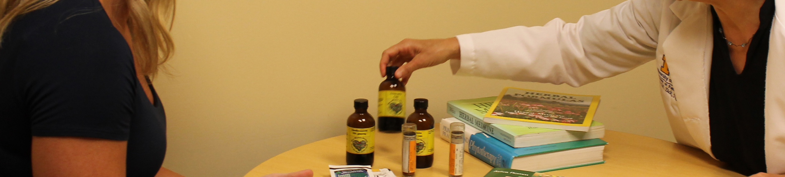 Close up of physician handing a supplement bottle to a patient