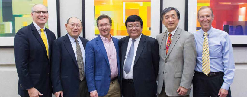 Sanduk Ruit, M.D. (center) with Michigan Medicine leadership