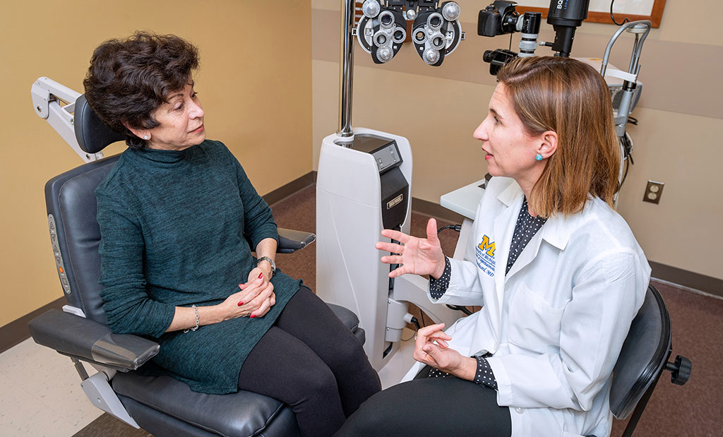 Cornea specialist, Dr. Maria Woodward, talks to a patient in an exam room