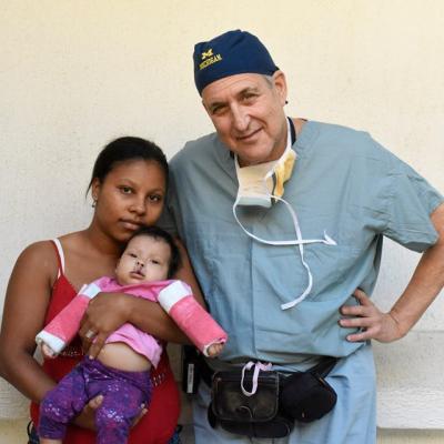 Dr. Gilman with patient and family member in Colombia