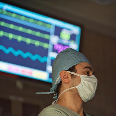 Surgical team member standing in front of a monitor