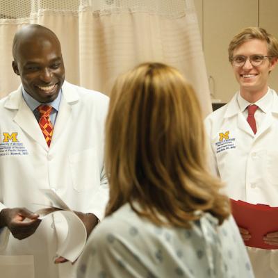 Dr. Momoh and Dr. Berlin talking to a patient in clinic
