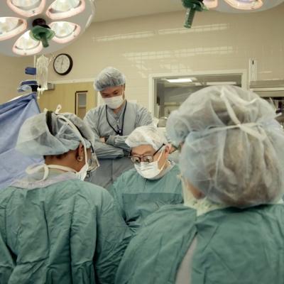 Physicians in green scrubs in operating room
