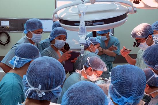 Group of surgeons observing in an operating room in Vietnam