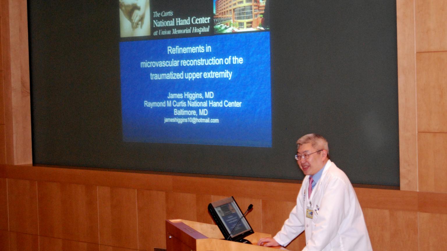 Dr. Chung speaking at a podium