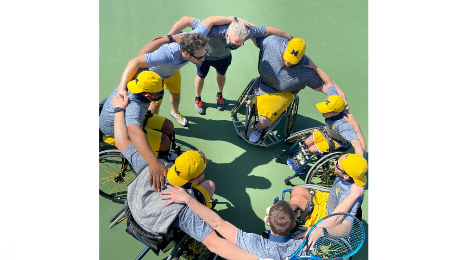 The tennis team huddles prior to their matches. 