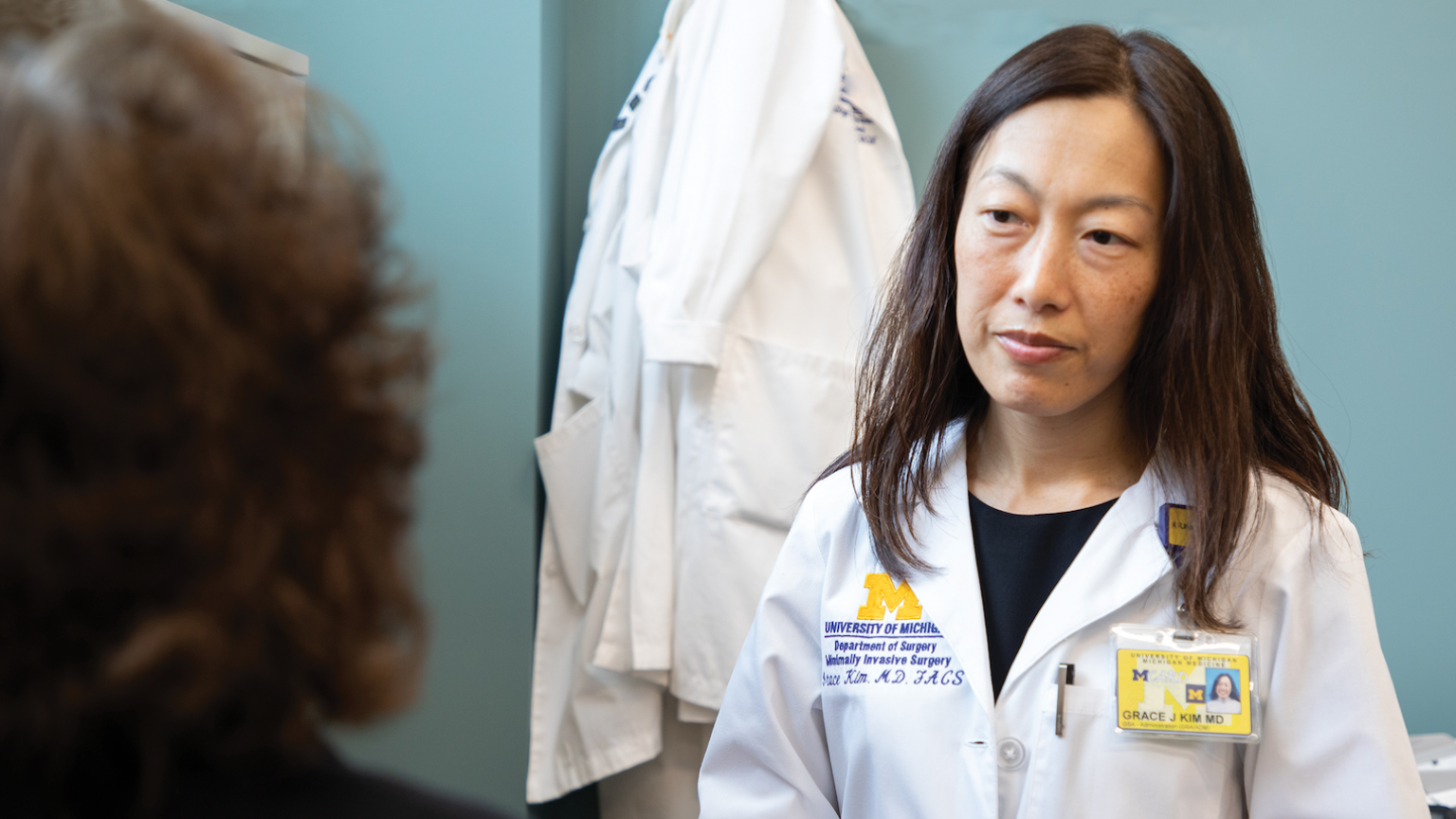 Dr. Grace Kim listening to a patient