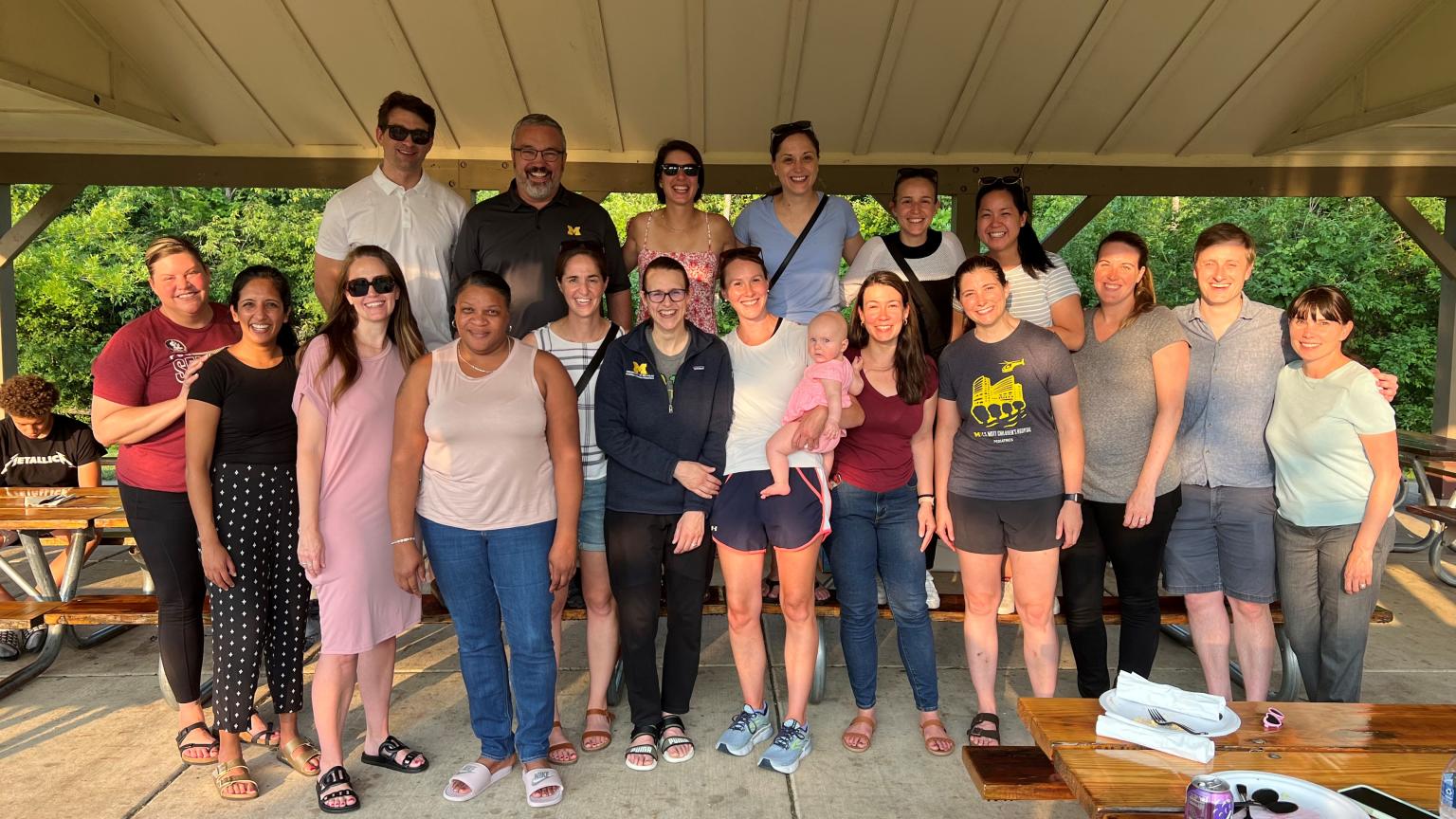 Group of Pediatric Hospital Medicine Fellows standing together smiling at a picnic.