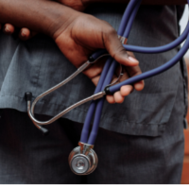 Hands of a dark skin color holding a stethoscope