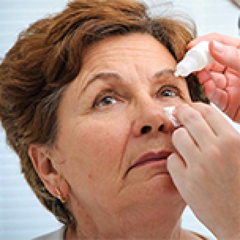 Woman receiving eye drops 