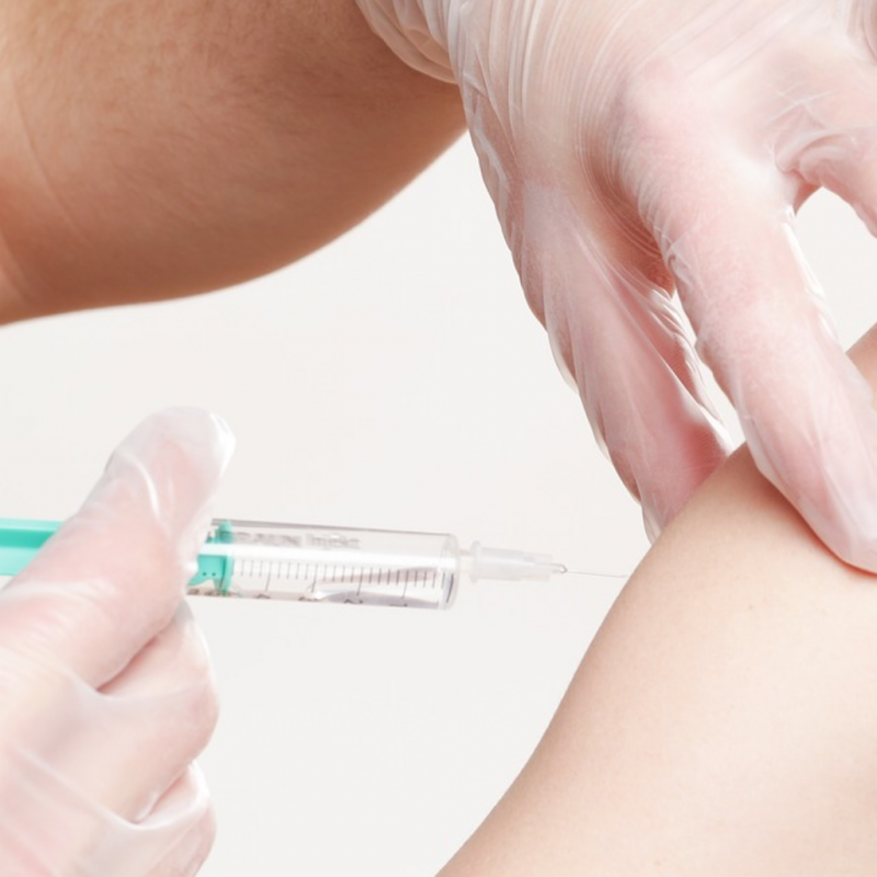 A close up of a vaccine being administered by an individual. 