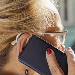 older woman on cell phone wearing hearing aid