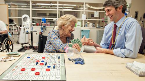 Dr. Ted Claflin playing cards with a stroke patient