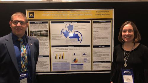 Thomas Bishop and Jill Fenske stand by a poster titled Finding a New Path: Moving a Clinic Toward Behavioral Integration to Improve Patient Care and Resident Teaching