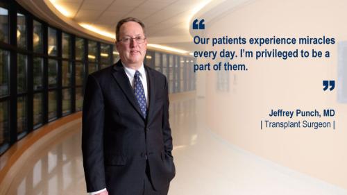Dr. Jeffrey Punch standing in a hallway and his #WeAreUmichSurgery quote