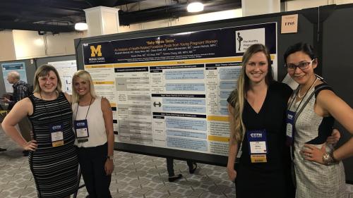 U-M Family Medicine residents with research poster and mentor Tammy Chang 