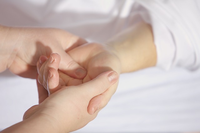 Acupressure treatment being performed on a hand. 